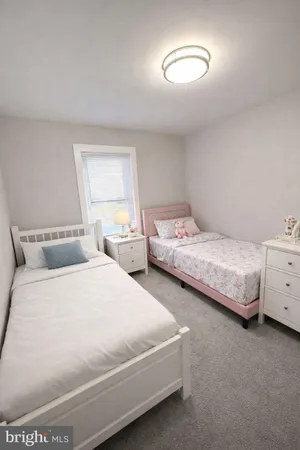 a bedroom with two beds and a chandelier