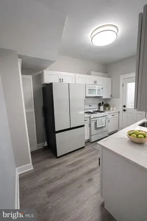 a kitchen with a refrigerator a stove top oven a sink and dishwasher