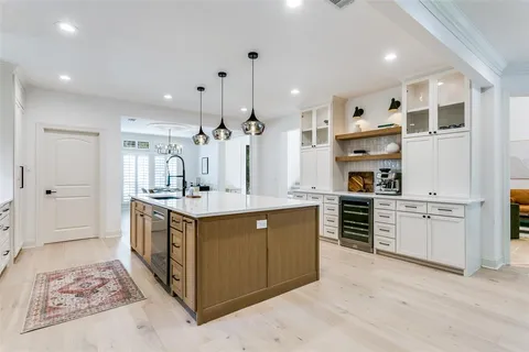 a kitchen with stainless steel appliances kitchen island granite countertop a stove and a sink