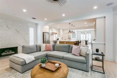 a living room with furniture kitchen view and a fireplace