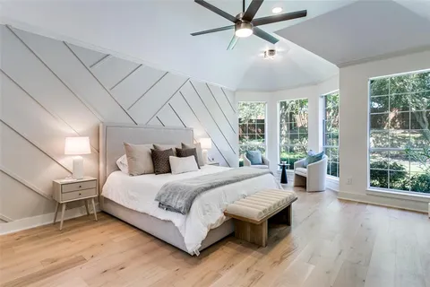 a bedroom with a large bed and a window