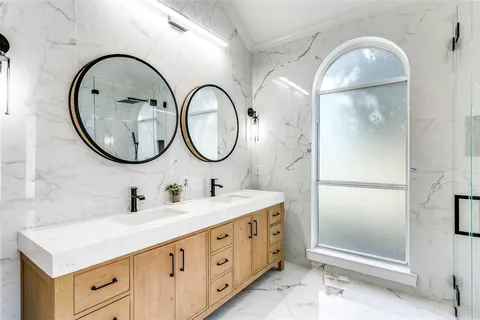 a bathroom with a double vanity sink and a mirror