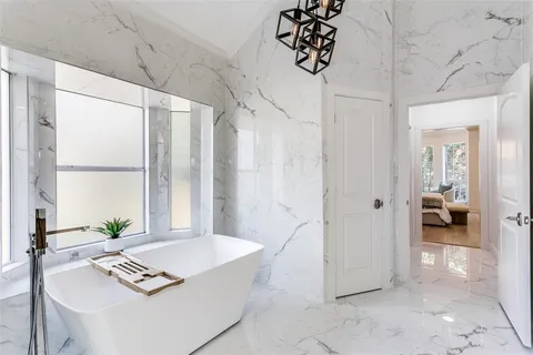 a view of a hallway and a livingroom with furniture