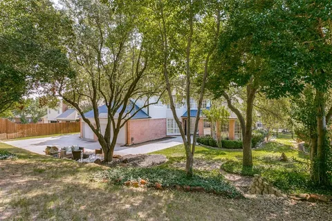 a view of a yard with a tree
