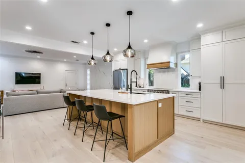 a kitchen with stainless steel appliances kitchen island a sink and cabinets