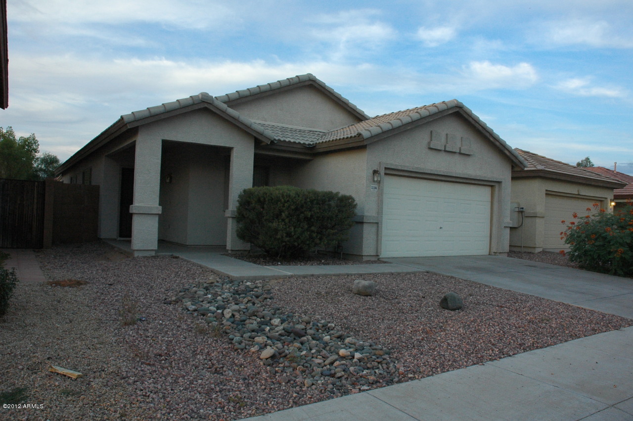 11186 West Berkeley Road Avondale, AZ 85392 - Photo 11 of 15 a view of a house with a yard and garage