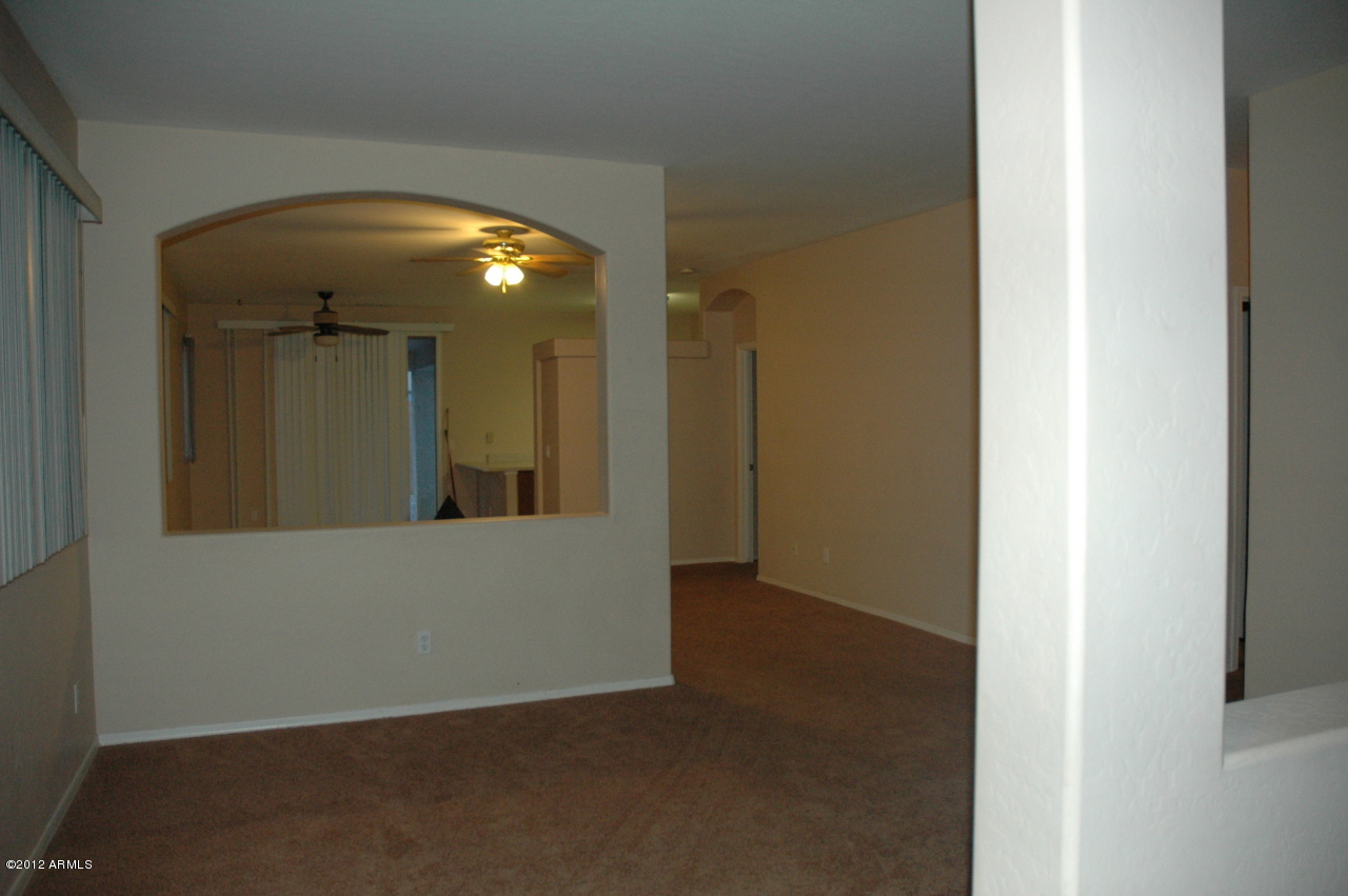 11186 West Berkeley Road Avondale, AZ 85392 - Photo 13 of 15 a view of a hallway with wooden floor