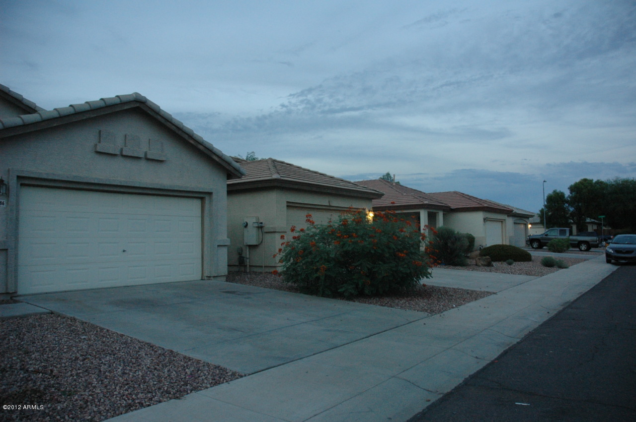 11186 West Berkeley Road Avondale, AZ 85392 - Photo 14 of 15 a front view of house with yard and trees around