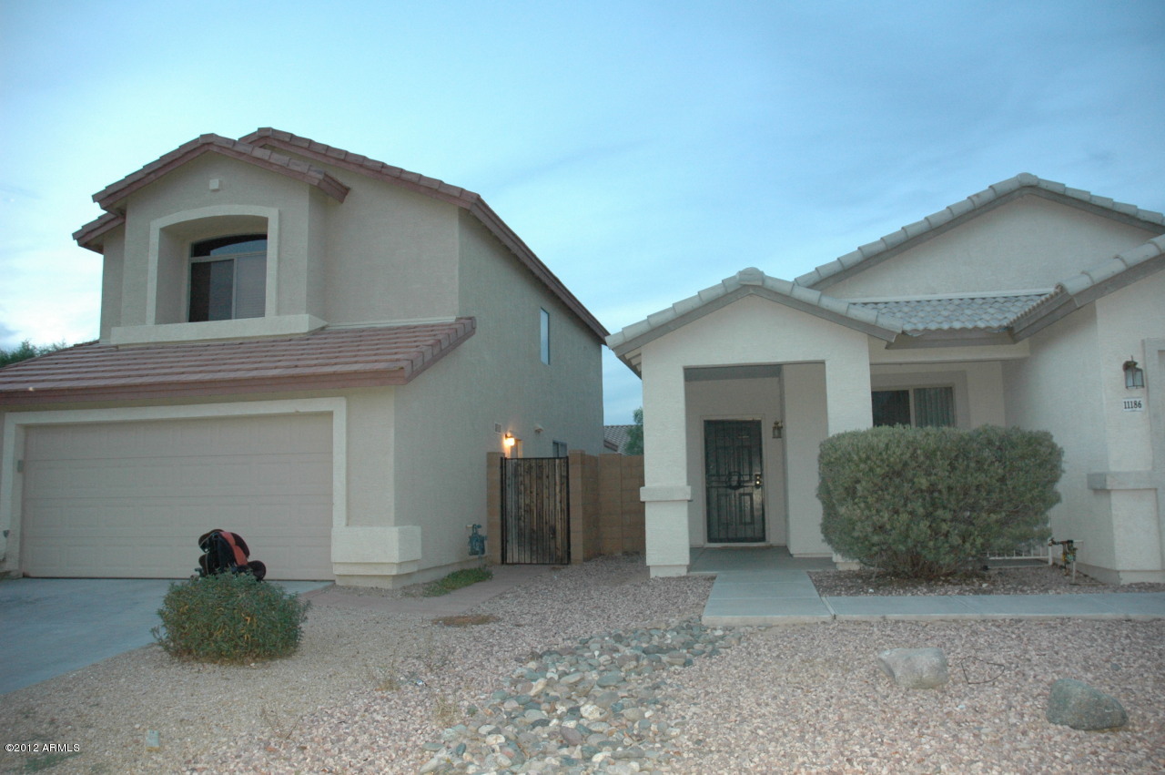 11186 West Berkeley Road Avondale, AZ 85392 - Photo 8 of 15 a view of a house with a yard and garage