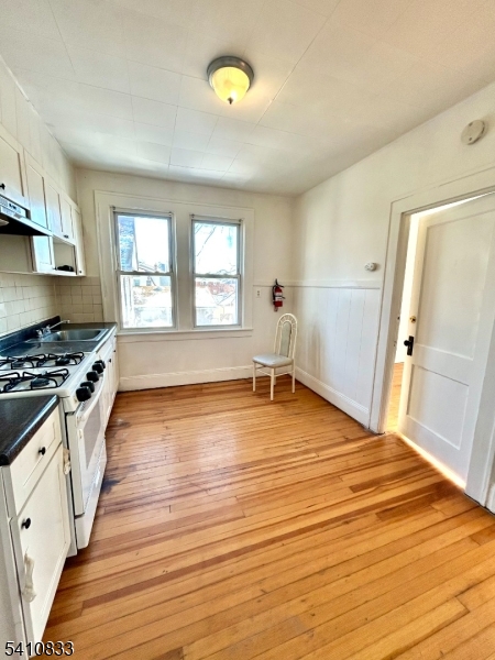 29 Adams Street, Unit 2 Irvington, NJ 07111 - Photo 11 of 14 a view of a kitchen with wooden floor and electronic appliances