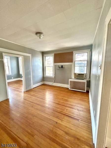 29 Adams Street, Unit 2 Irvington, NJ 07111 - Photo 2 of 14 a view of empty room with wooden floor and fan