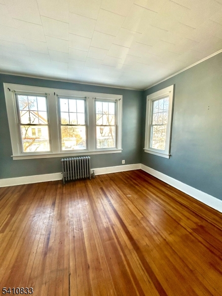 29 Adams Street, Unit 2 Irvington, NJ 07111 - Photo 4 of 14 an empty room with wooden floor and windows