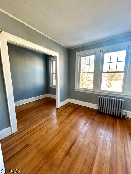 29 Adams Street, Unit 2 Irvington, NJ 07111 - Photo 6 of 14 an empty room with wooden floor and windows
