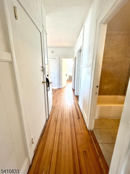 29 Adams Street, Unit 2 Irvington, NJ 07111 - Photo 7 of 14 a view of a hallway with wooden floor and staircase