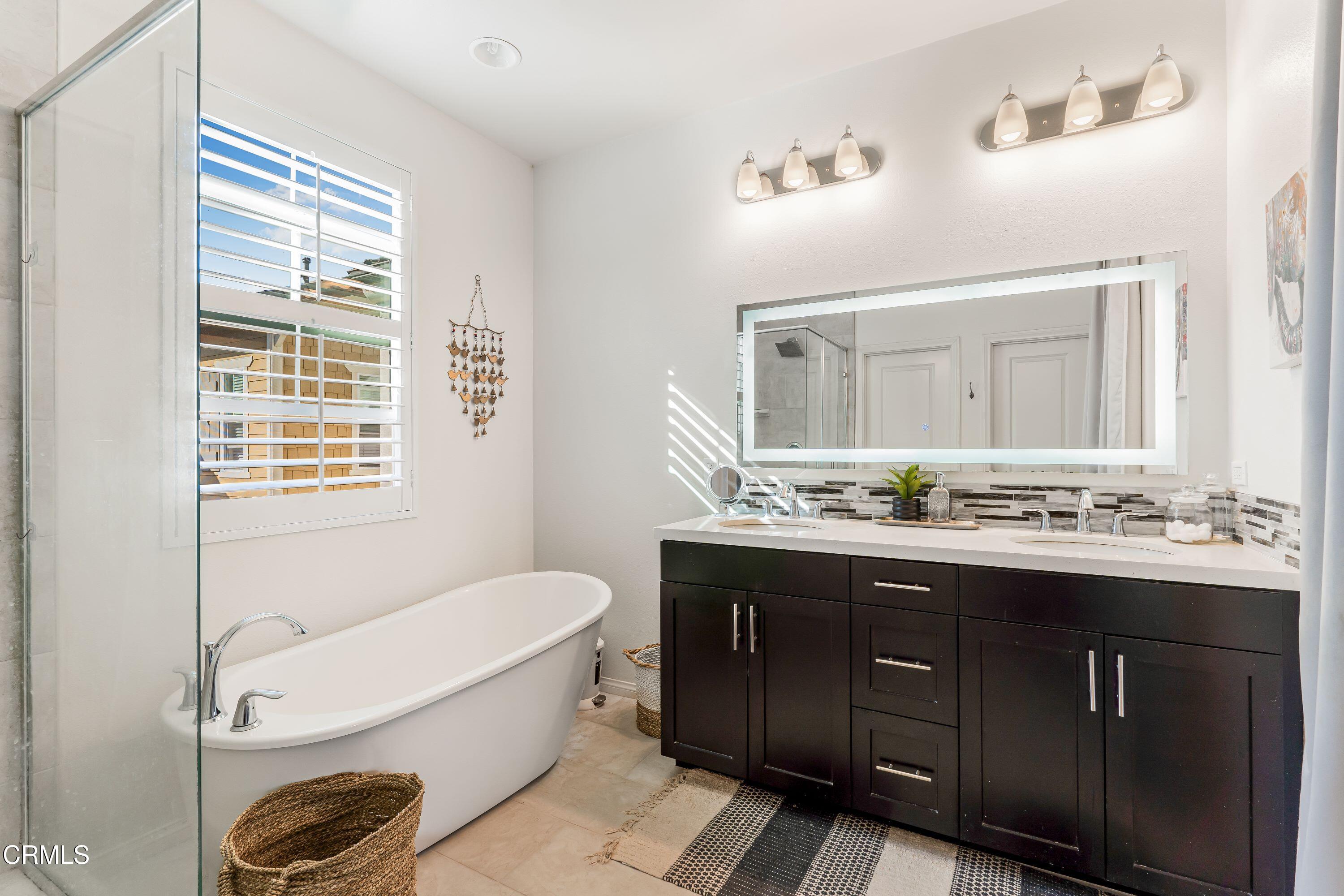 241 Stonegate Road Camarillo, CA 93010 - Photo 16 of 33 a bathroom with a tub a sink and wooden floor