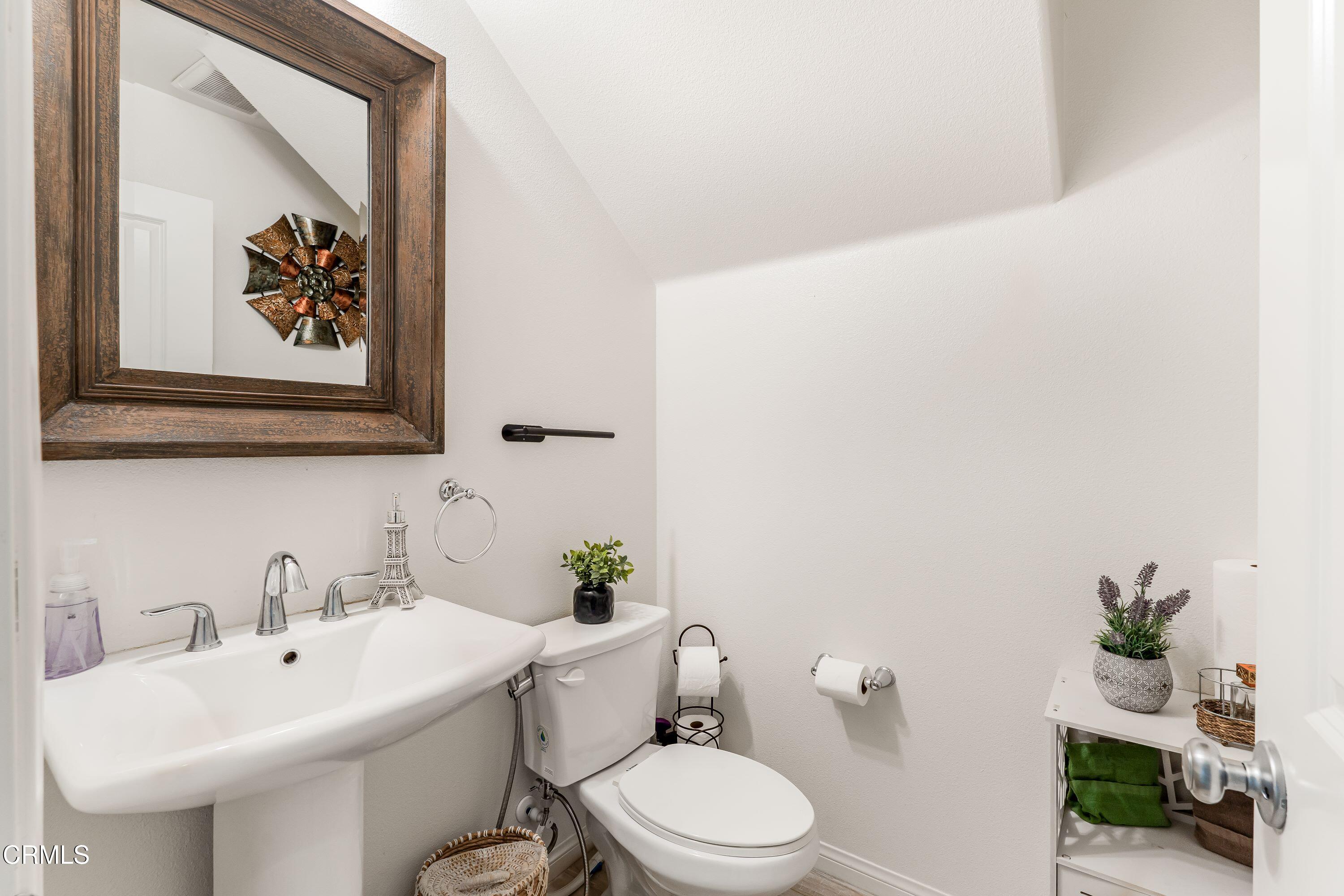 241 Stonegate Road Camarillo, CA 93010 - Photo 25 of 33 a white toilet sitting next to a bathroom sink