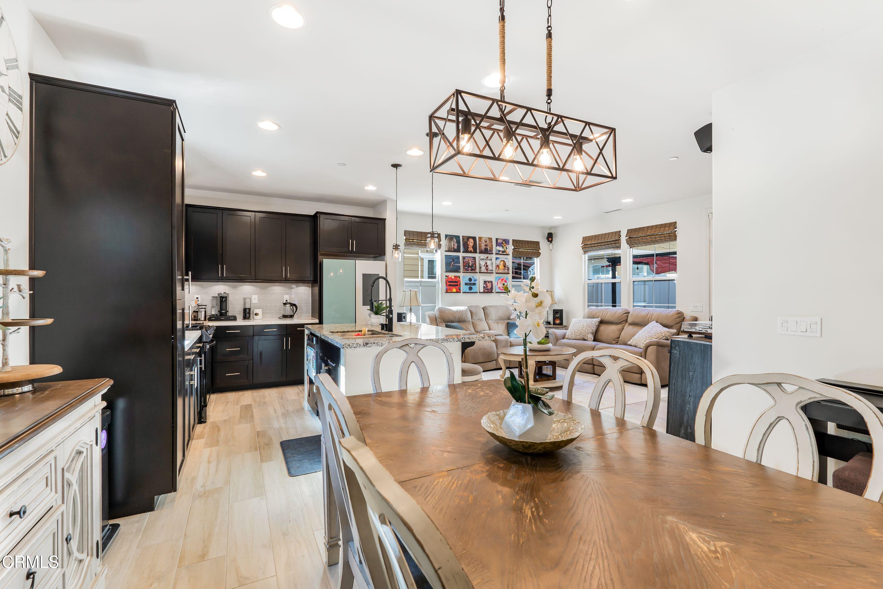 241 Stonegate Road Camarillo, CA 93010 - Photo 6 of 33 a view of a dining room and livingroom with furniture wooden floor a chandelier