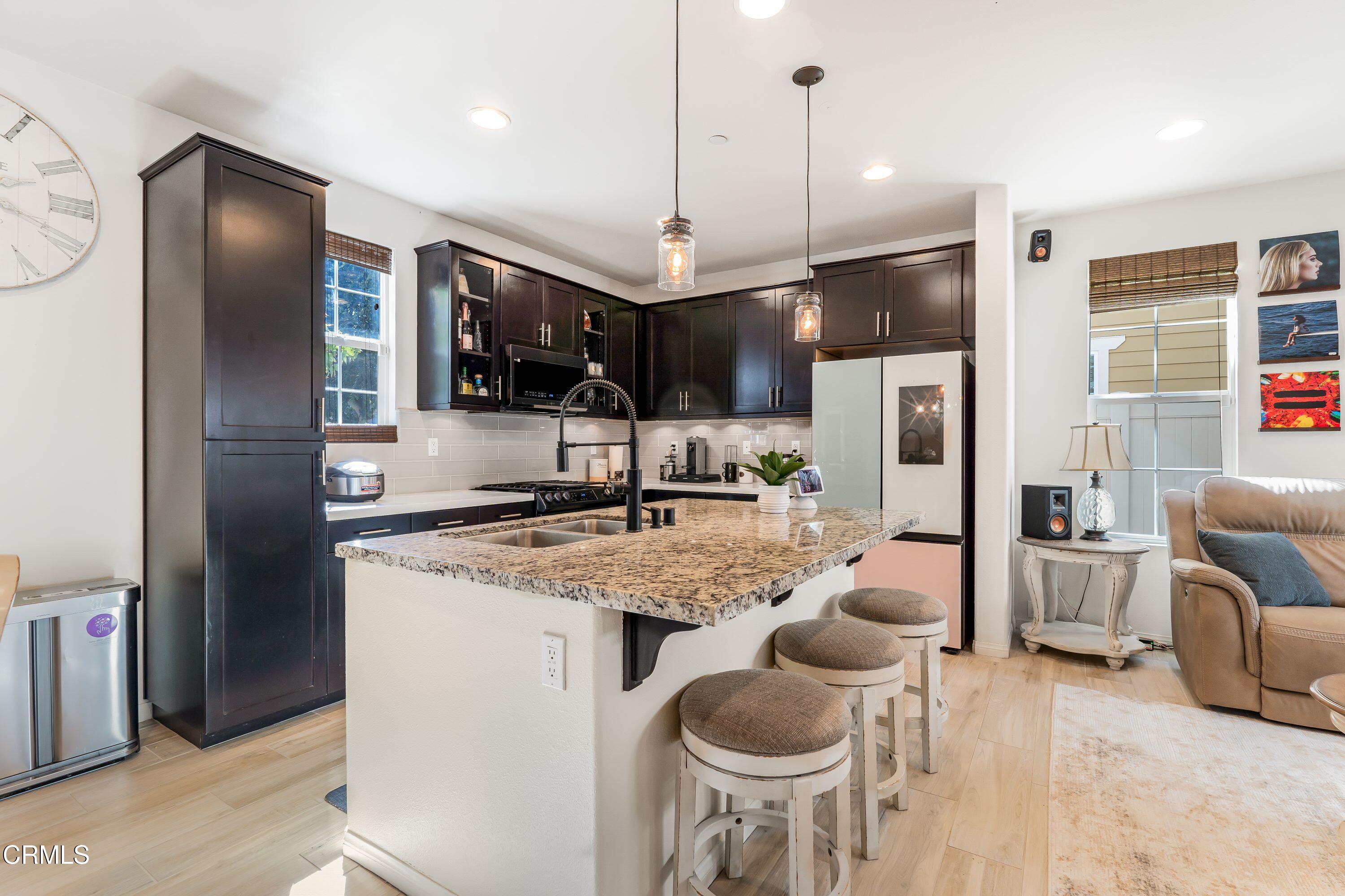 241 Stonegate Road Camarillo, CA 93010 - Photo 8 of 33 a kitchen with stainless steel appliances granite countertop a sink refrigerator and cabinets