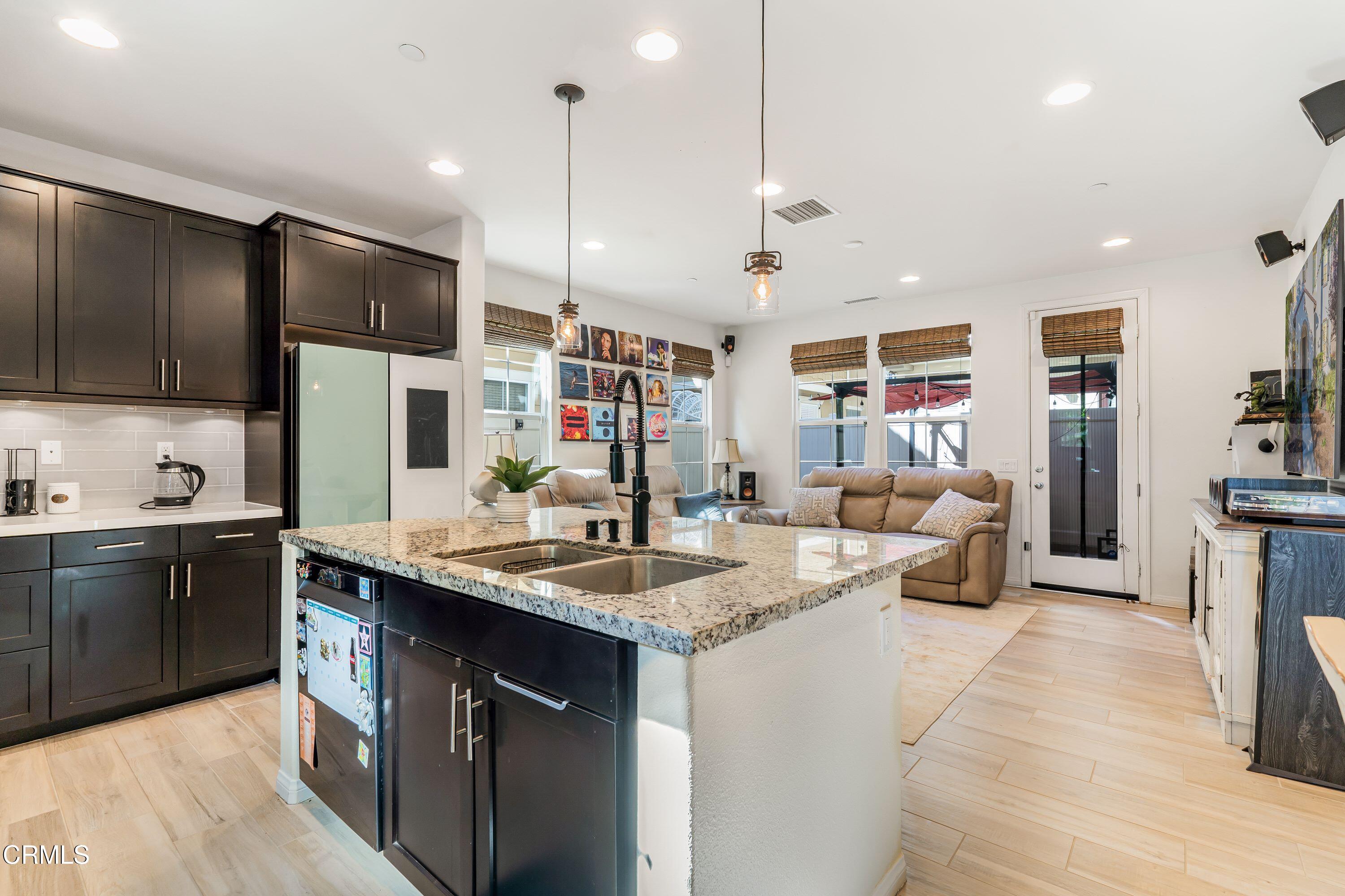 241 Stonegate Road Camarillo, CA 93010 - Photo 9 of 33 a kitchen with stainless steel appliances granite countertop a sink a stove and a wooden floors