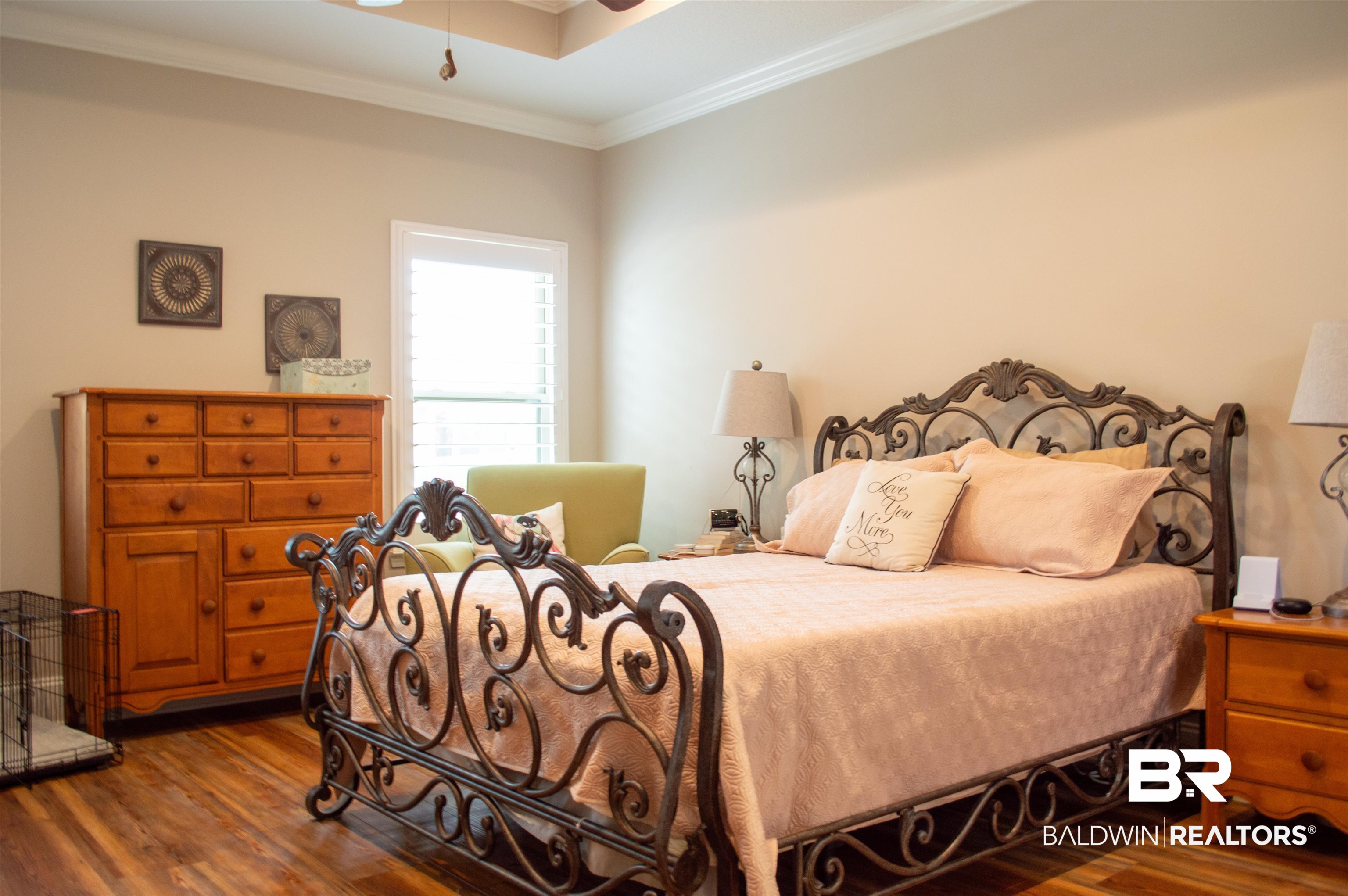 1124 West Orlando Drive Foley, AL 36535 - Photo 18 of 51 Bedroom featuring ornamental molding, dark wood finished floors, a ceiling fan, and a raised ceiling