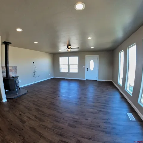 a kitchen with stainless steel appliances wooden floor and a refrigerator