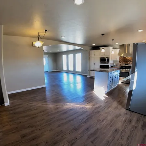 an empty room with a window and a ceiling fan
