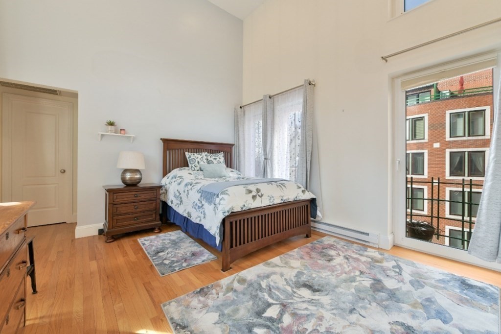 492 Beacon Street, Unit 82 Boston, MA 02115 - Photo 12 of 21 a bedroom with a bed and a large window