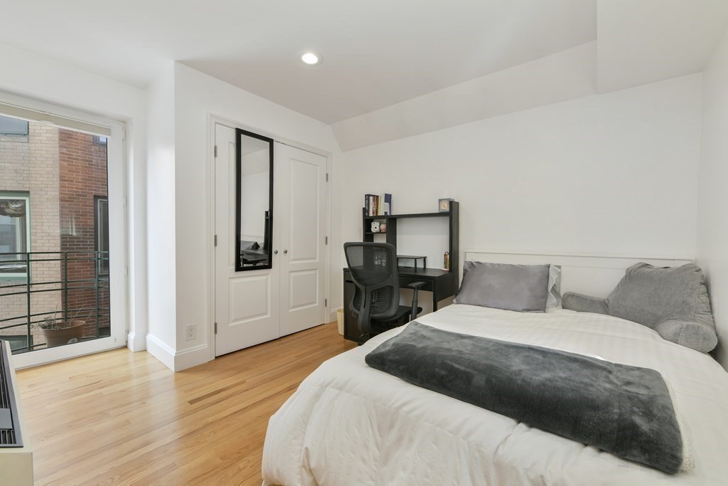 492 Beacon Street, Unit 82 Boston, MA 02115 - Photo 14 of 21 a bedroom with a bed and wooden floor