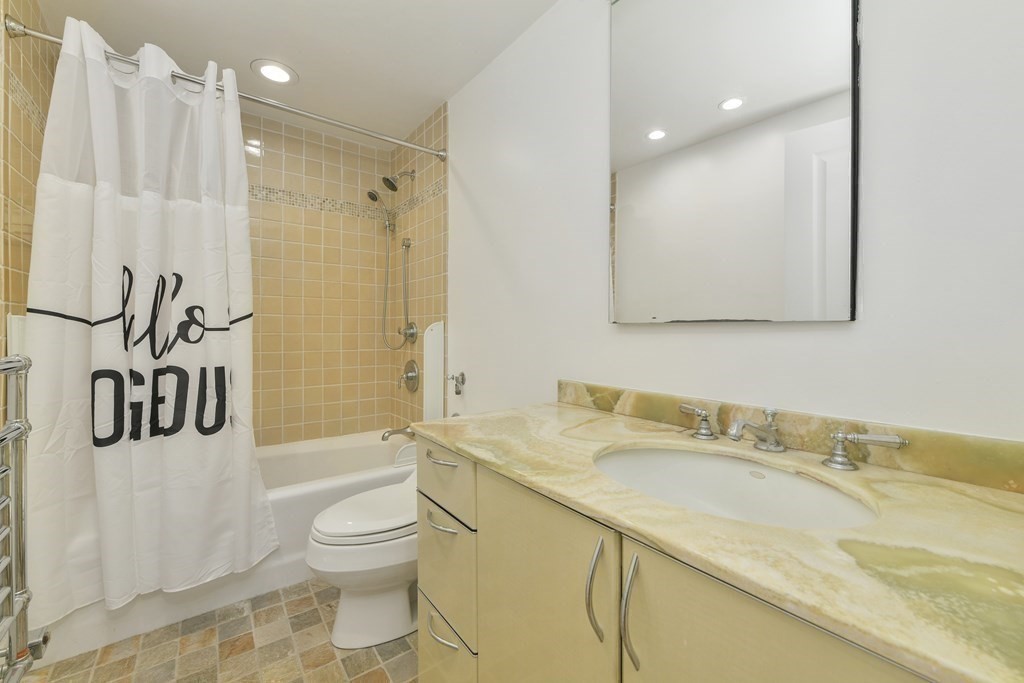 492 Beacon Street, Unit 82 Boston, MA 02115 - Photo 15 of 21 a bathroom with a granite countertop sink a toilet and shower