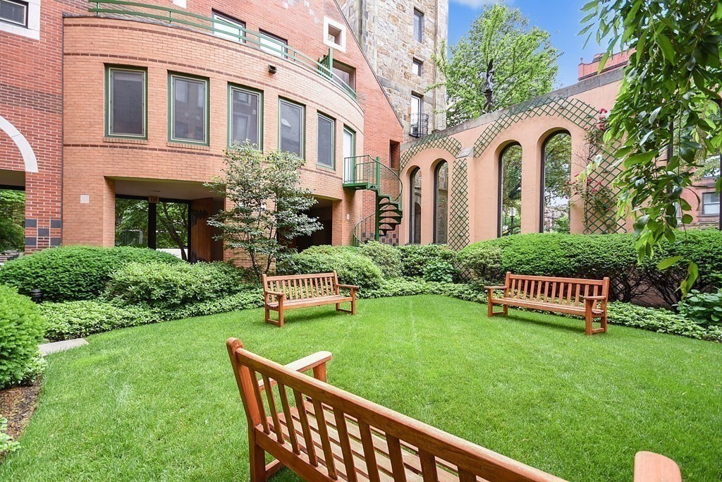 492 Beacon Street, Unit 82 Boston, MA 02115 - Photo 18 of 21 a front view of a house with a yard table and chairs