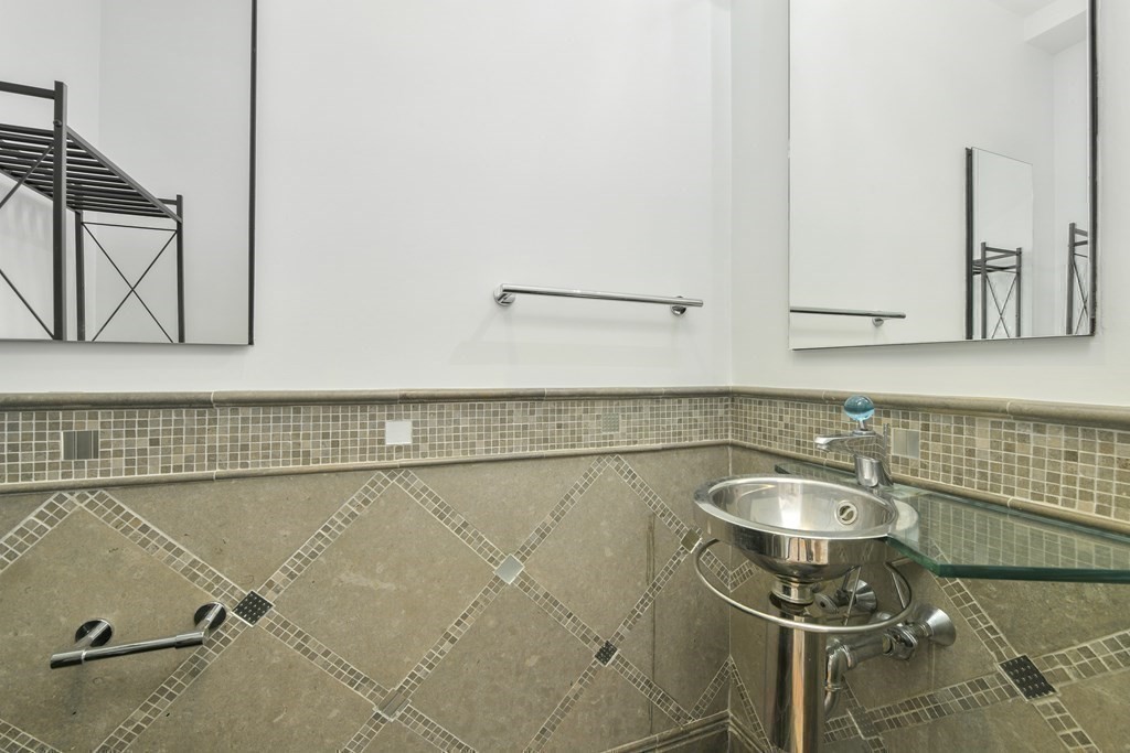 492 Beacon Street, Unit 82 Boston, MA 02115 - Photo 8 of 21 a bathroom with a sink and a mirror