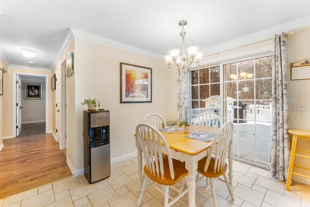 a dining room with furniture and chandelier kitchen view