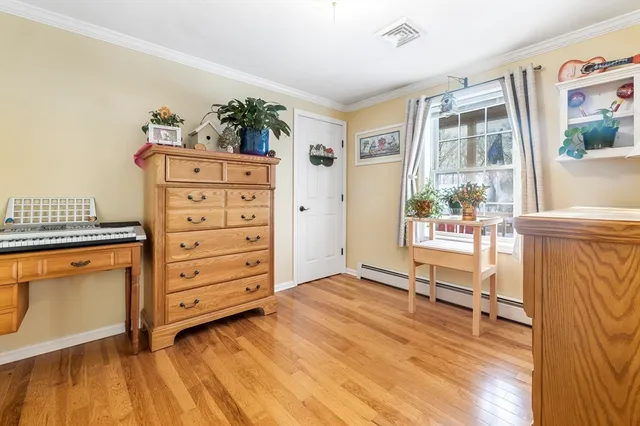 a room with dresser and window