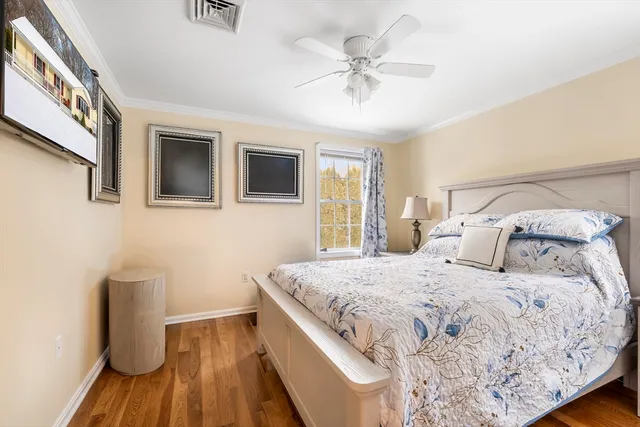 a bedroom with bed and wooden floor