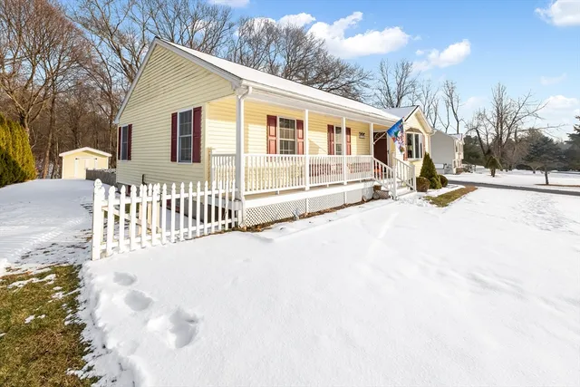 a view of a house with a wooden fence