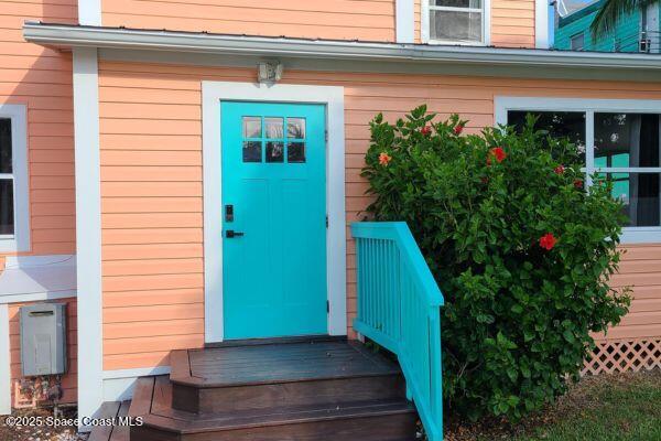 693 Law Street, Unit B Melbourne, FL 32935 - Photo 1 of 8 a view of a house with a flower garden