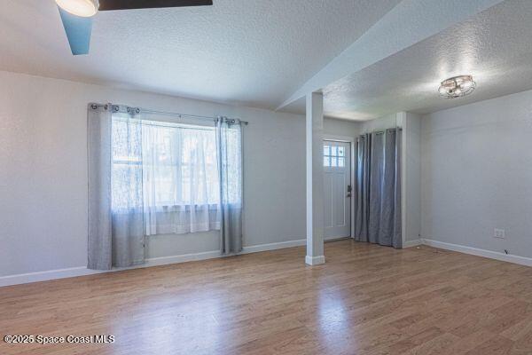 693 Law Street, Unit B Melbourne, FL 32935 - Photo 3 of 8 an empty room with wooden floor and windows