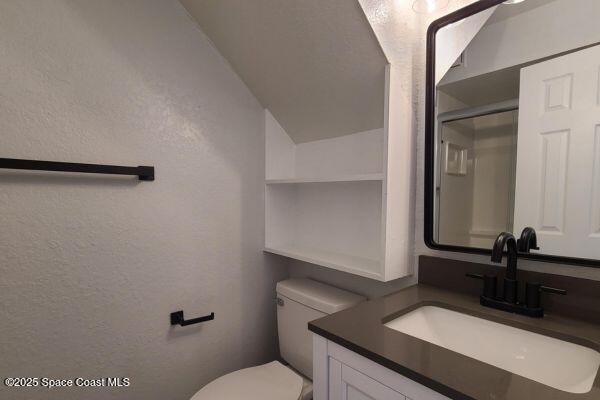 693 Law Street, Unit B Melbourne, FL 32935 - Photo 5 of 8 a bathroom with a sink a toilet and mirror