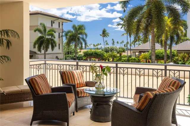 a view of a chair and tables in the balcony