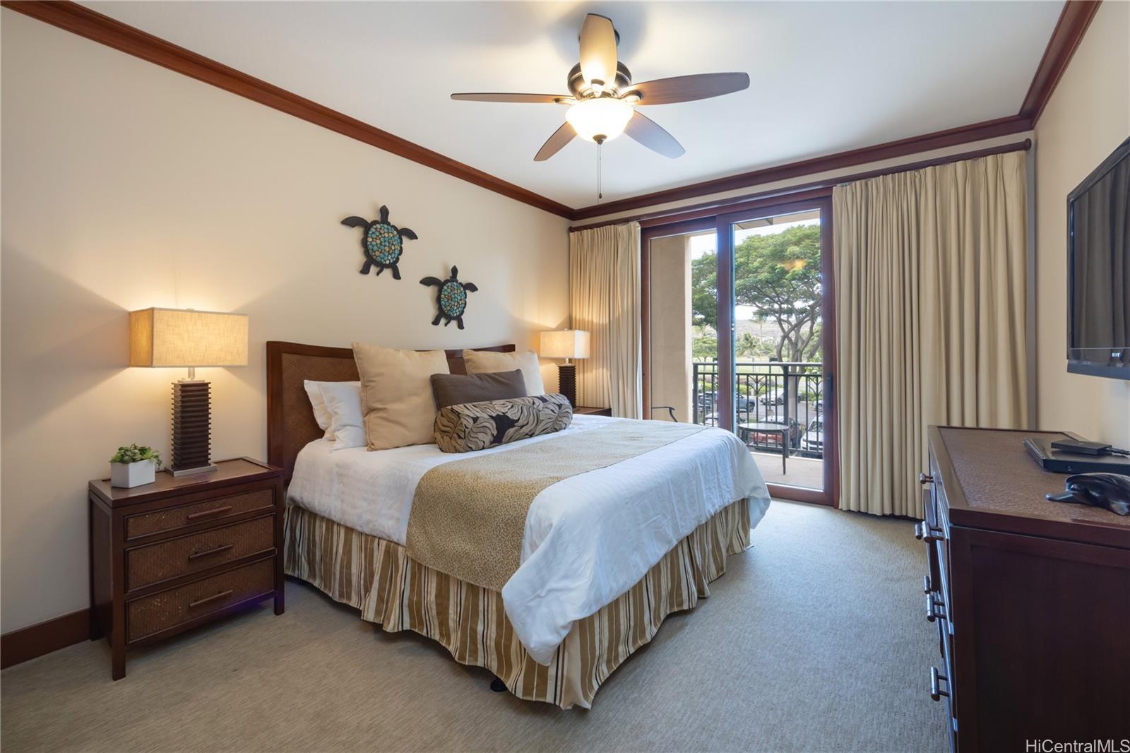 92-104 Waialii Place, Unit O202 Kapolei, HI 96707 - Photo 14 of 25 a bedroom with a bed chandelier and a window