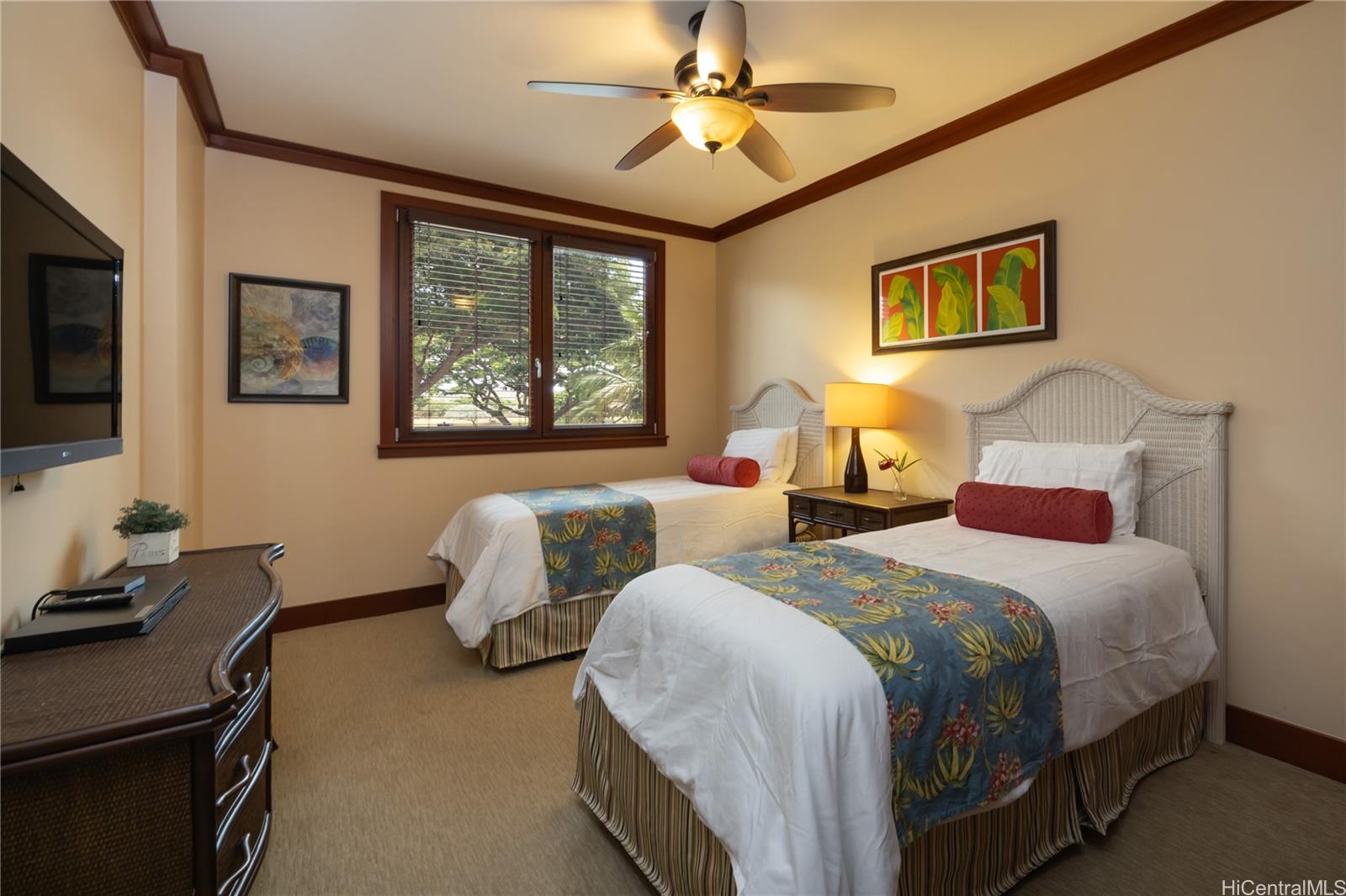 92-104 Waialii Place, Unit O202 Kapolei, HI 96707 - Photo 17 of 25 a bedroom with two beds and a flat screen tv