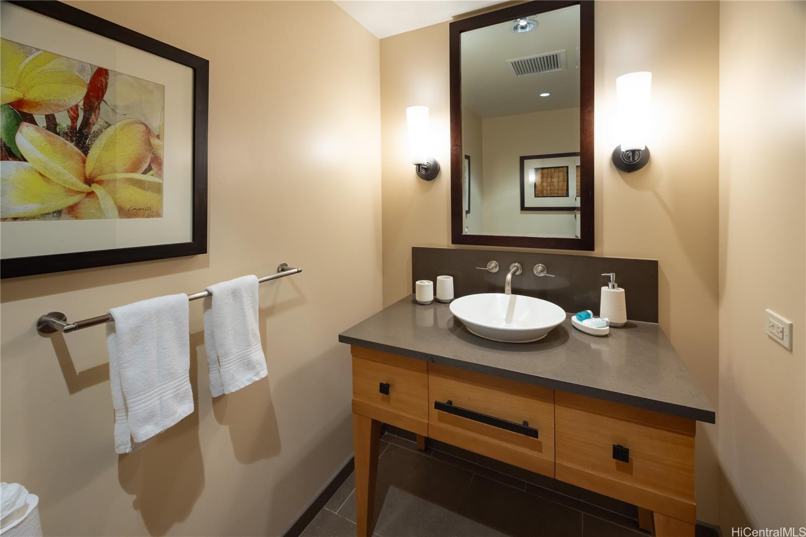 92-104 Waialii Place, Unit O202 Kapolei, HI 96707 - Photo 21 of 25 a bathroom with a sink and mirror