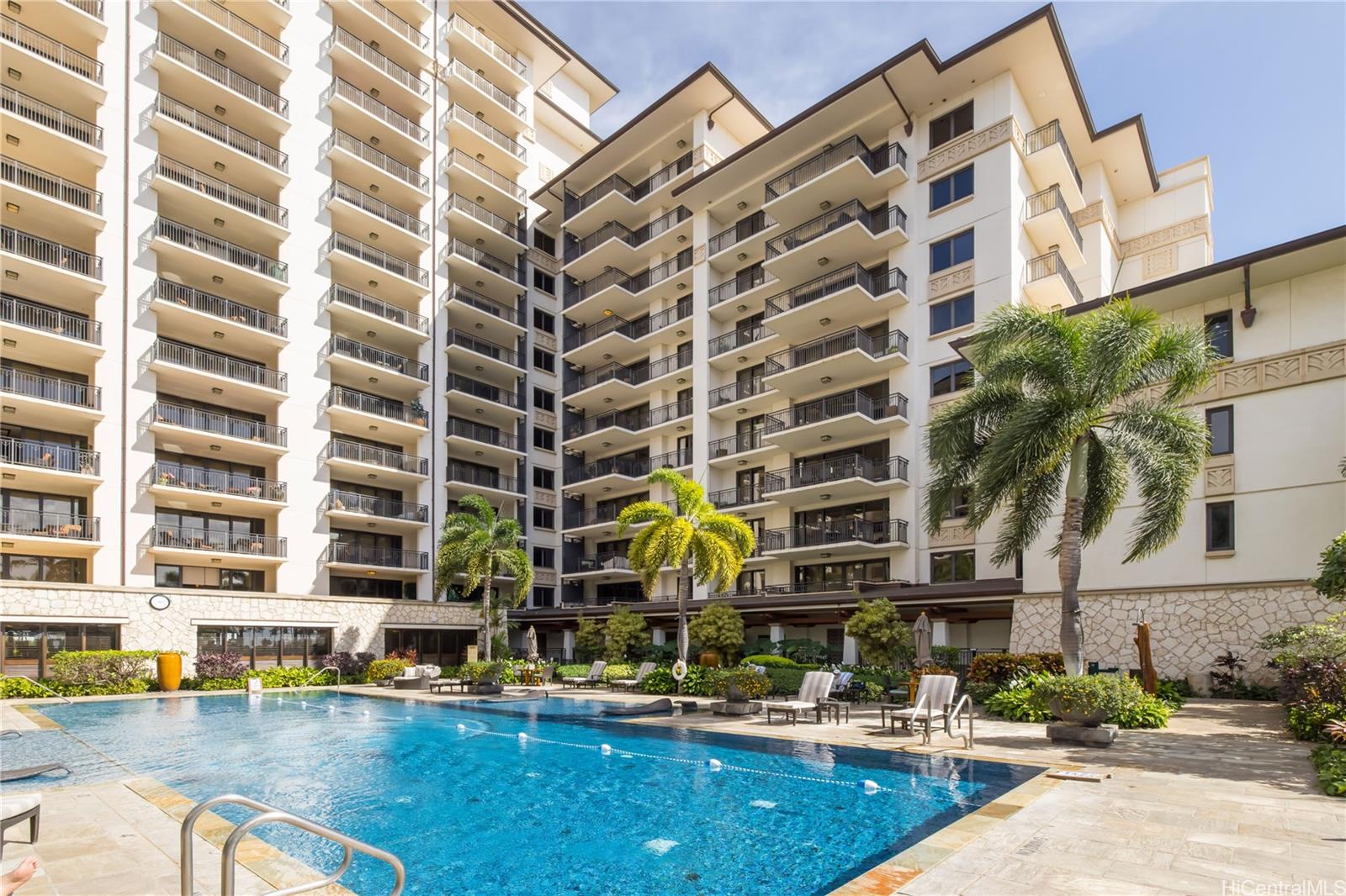 92-104 Waialii Place, Unit O202 Kapolei, HI 96707 - Photo 23 of 25 a building with swimming pool and glass windows