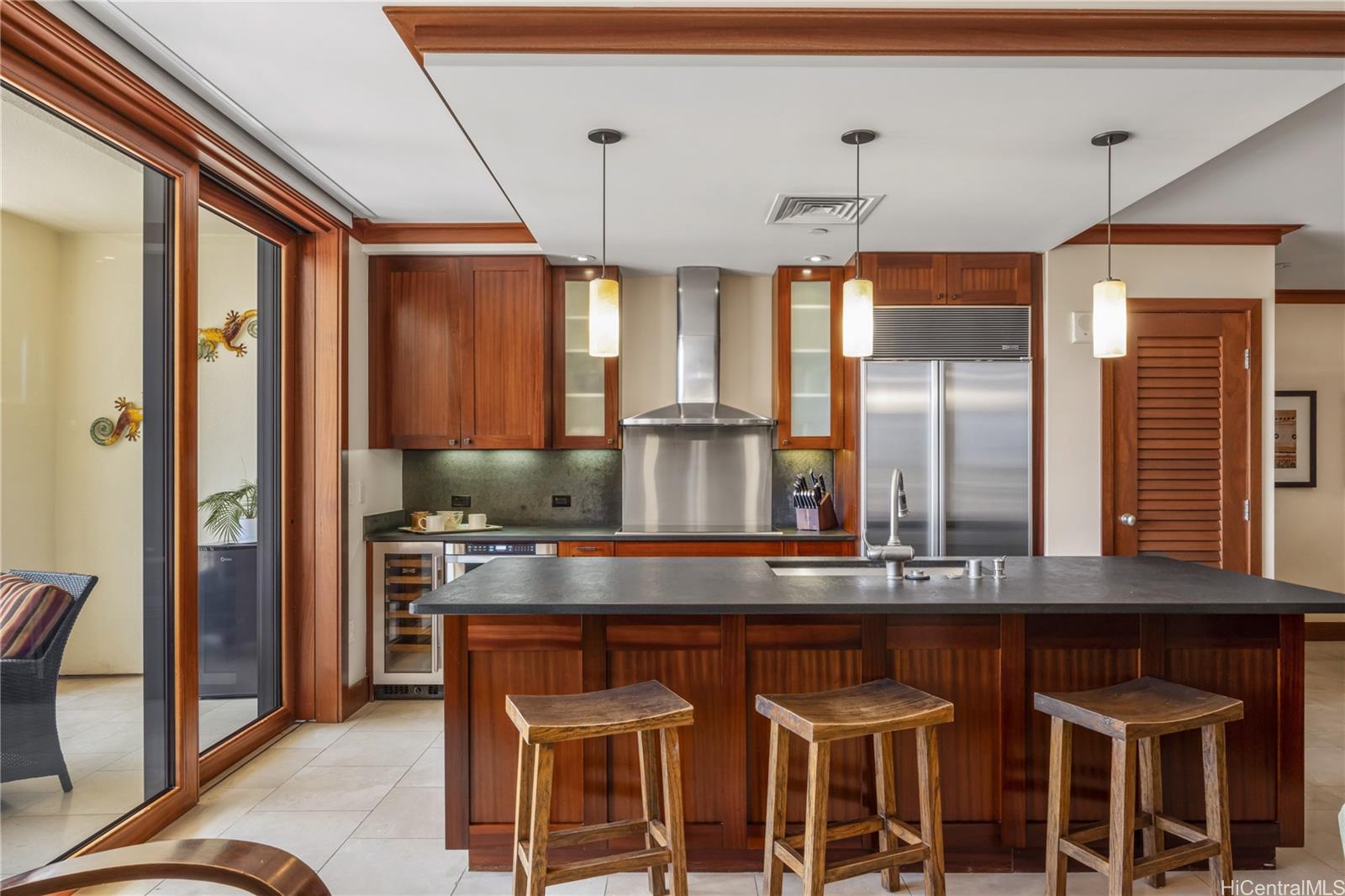 92-104 Waialii Place, Unit O202 Kapolei, HI 96707 - Photo 5 of 25 a kitchen with a dining table chairs stainless steel appliances and cabinets