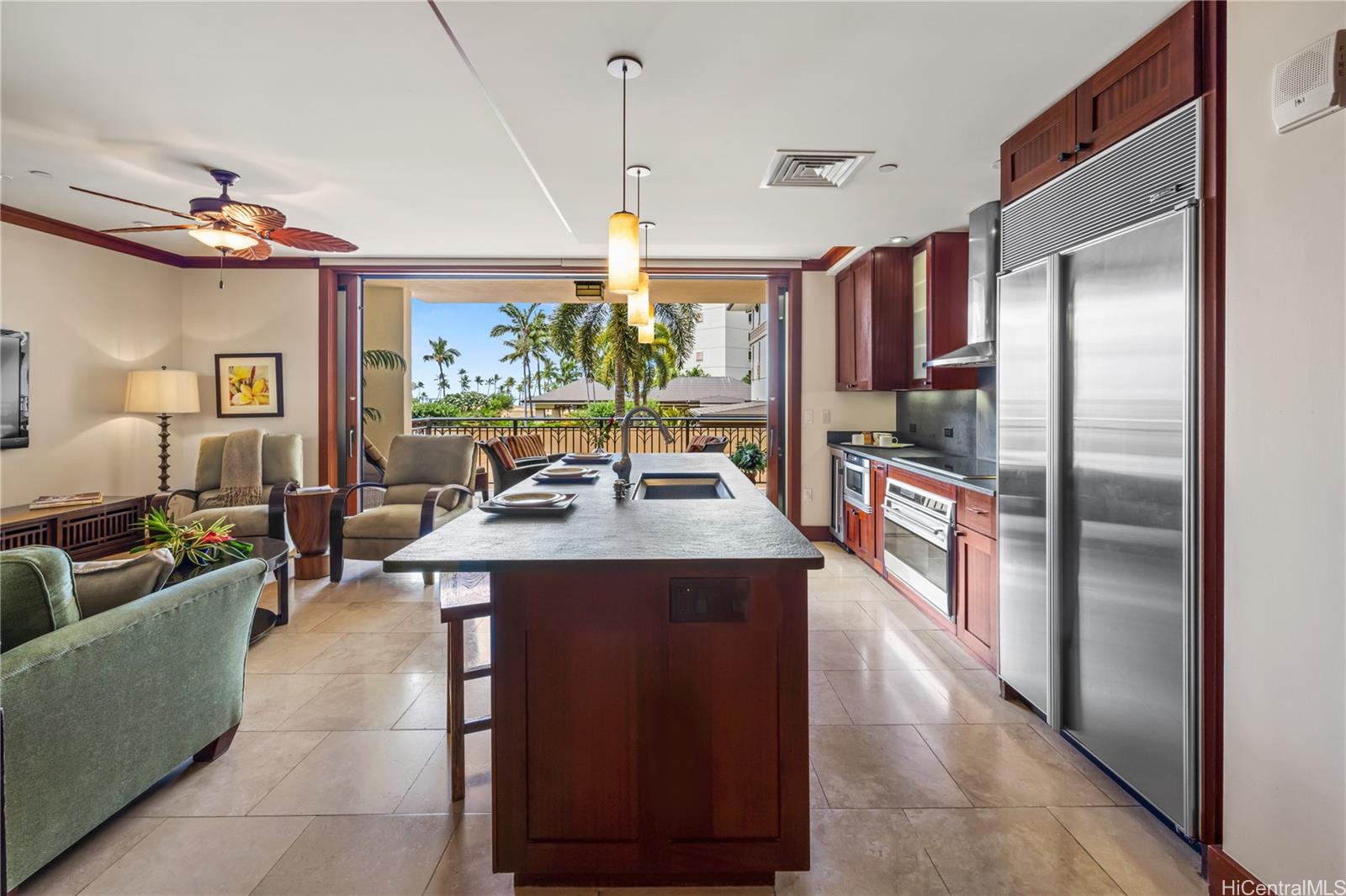 92-104 Waialii Place, Unit O202 Kapolei, HI 96707 - Photo 7 of 25 a living room with stainless steel appliances granite countertop furniture a fireplace and a chandelier