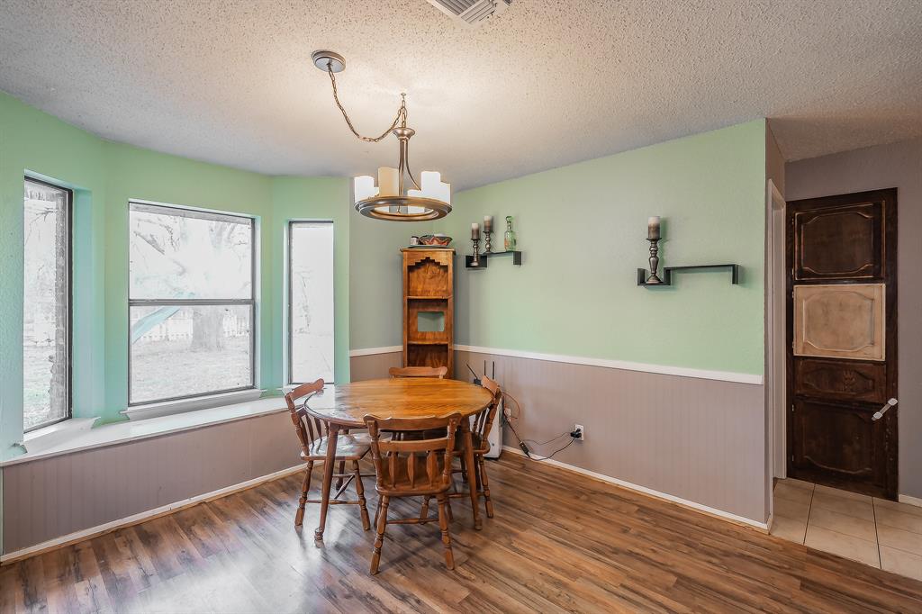 102 Perdue Circle Weatherford, TX 76085 - Photo 11 of 39 a view of a dining room with furniture window and wooden floor