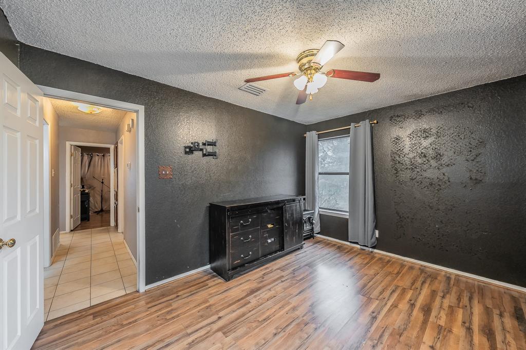 102 Perdue Circle Weatherford, TX 76085 - Photo 16 of 39 a view of an empty room with wooden floor and a fireplace