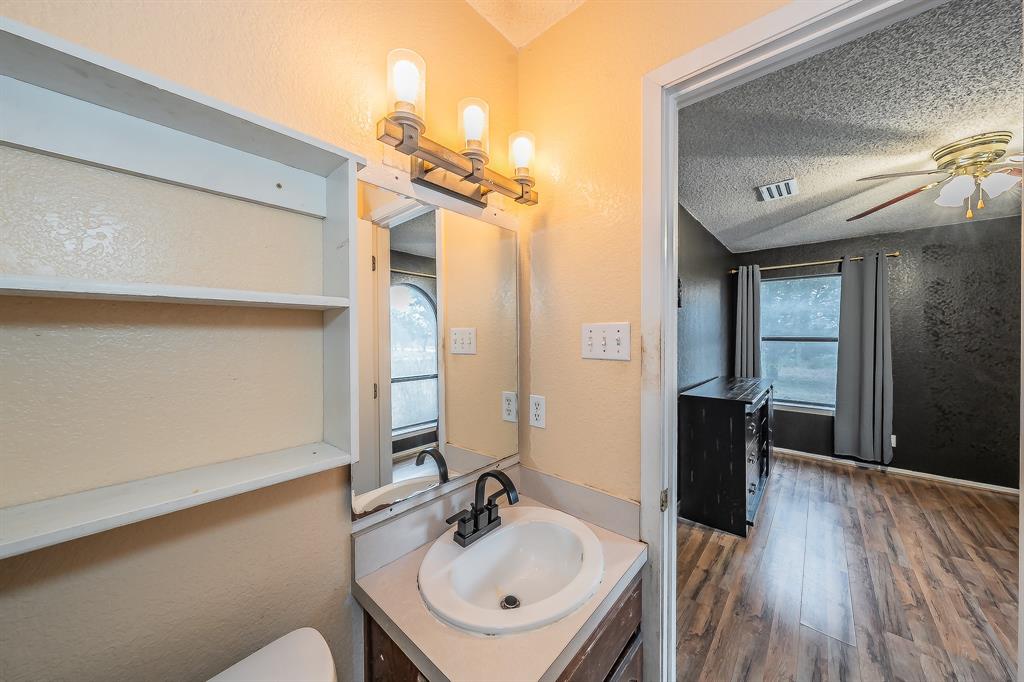 102 Perdue Circle Weatherford, TX 76085 - Photo 18 of 39 a bathroom with a sink and a mirror