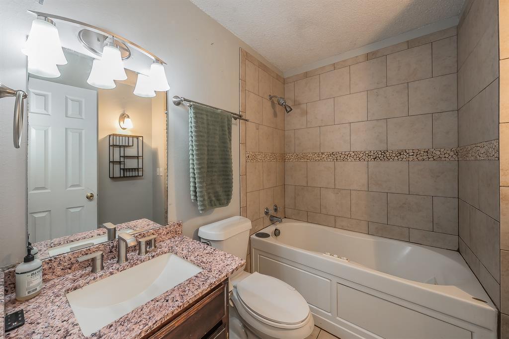 102 Perdue Circle Weatherford, TX 76085 - Photo 21 of 39 a bathroom with a granite countertop sink toilet and shower