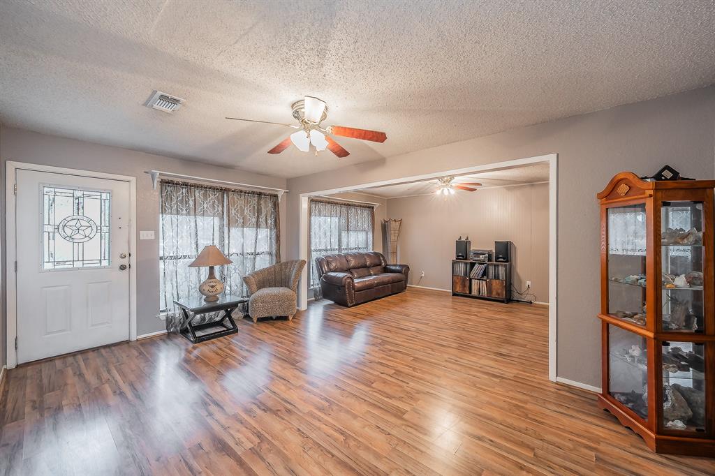 102 Perdue Circle Weatherford, TX 76085 - Photo 4 of 39 a view of a livingroom with furniture hardwood floor and a ceiling fan